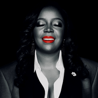 A business mogul, wearing bright red lipstick, basking in GOD's glory!